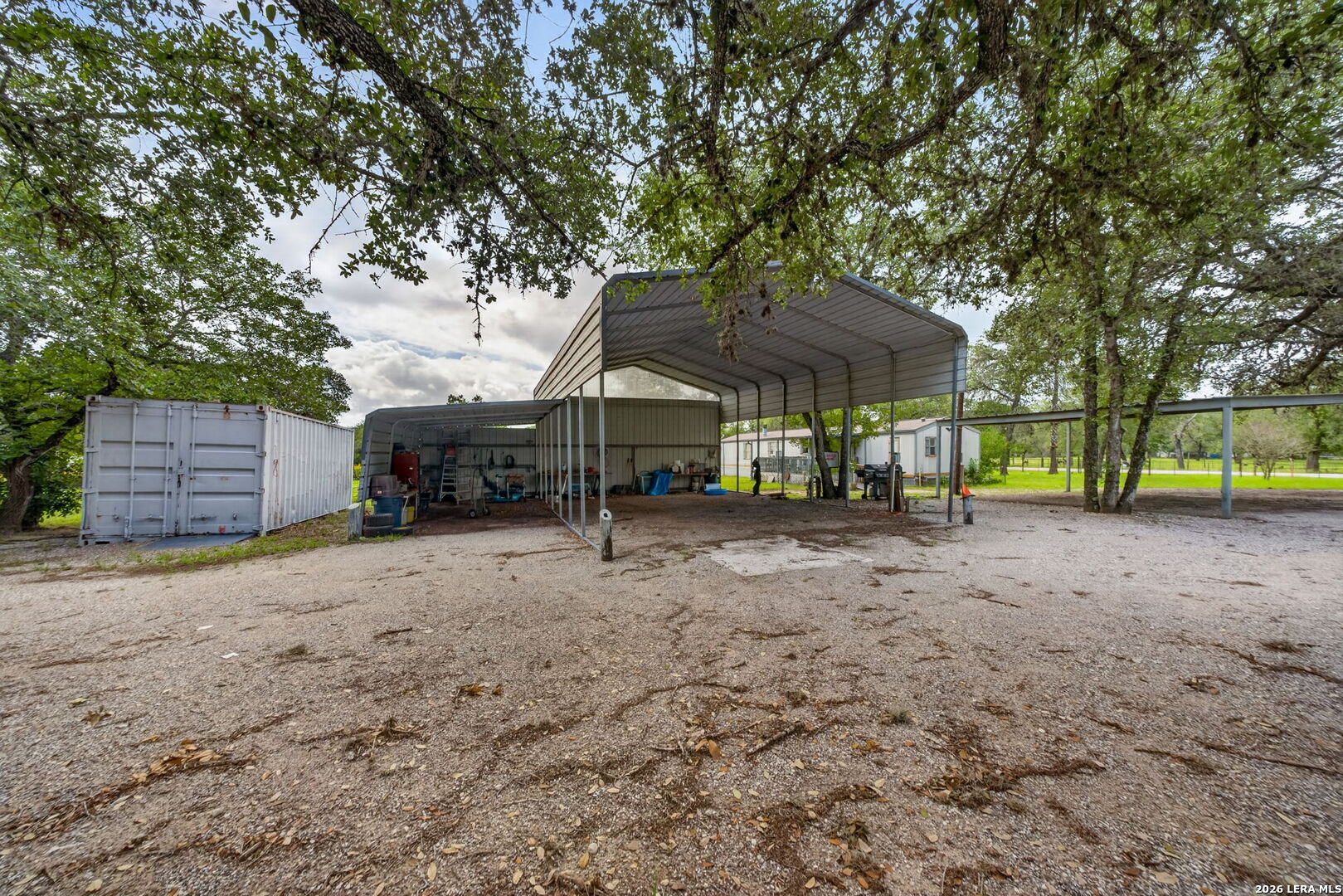23398 Mathis Road Elmendorf, TX 78112 - Photo 12 of 18 a view of a house with a yard and sitting area