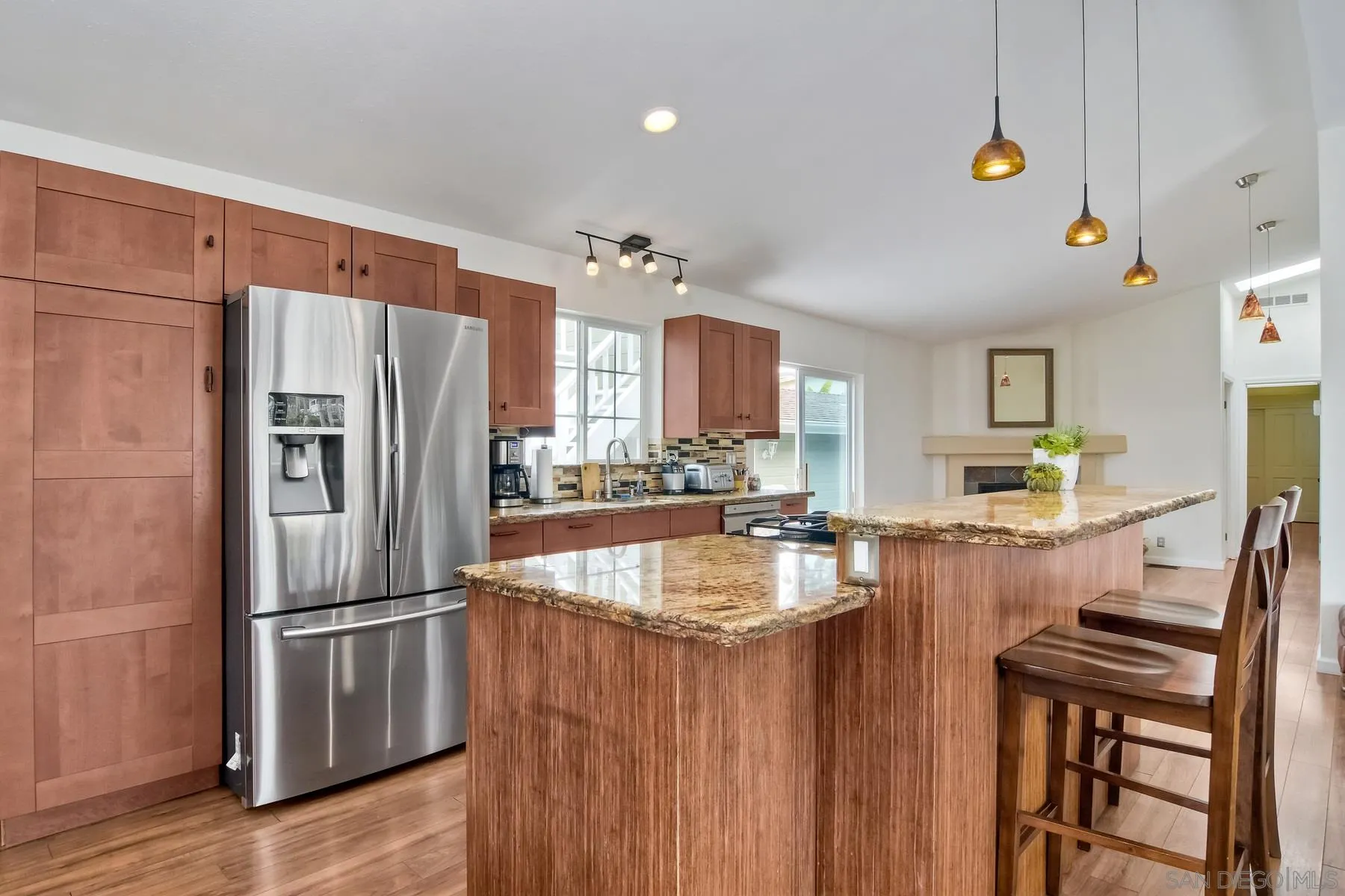 1245 Windsor Road Encinitas, CA 92007 - Photo 8 of 25 a kitchen with stainless steel appliances granite countertop a refrigerator a stove and a sink with wooden floor