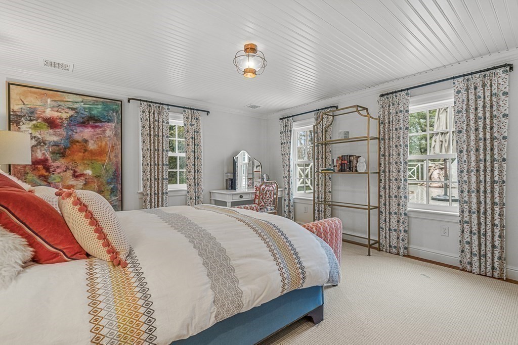 15 Woodcliff Road Wellesley, MA 02481 - Photo 20 of 31 a bedroom with a large bed and a chandelier