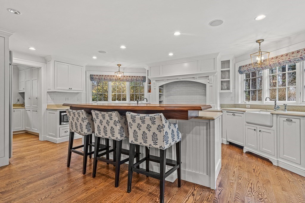 15 Woodcliff Road Wellesley, MA 02481 - Photo 10 of 31 a kitchen with stainless steel appliances kitchen island granite countertop a table chairs sink and cabinets