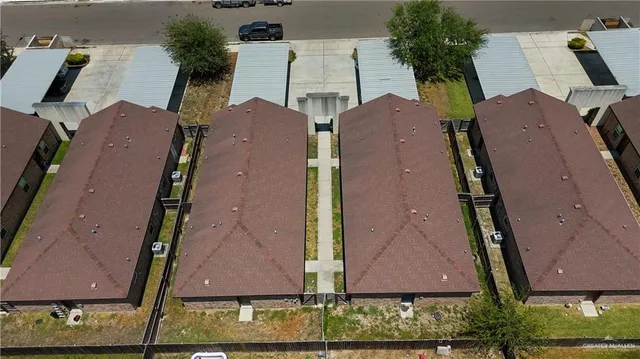 an aerial view of houses with yard