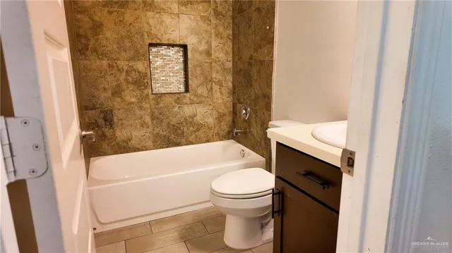 a bathroom with a toilet and a bathtub
