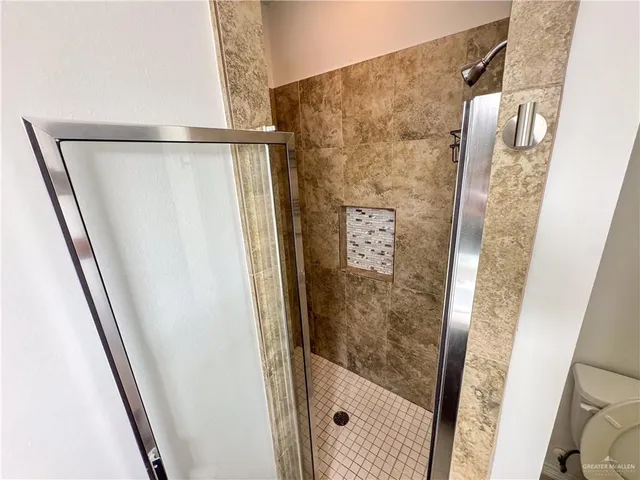 a bathroom with a shower and a sink