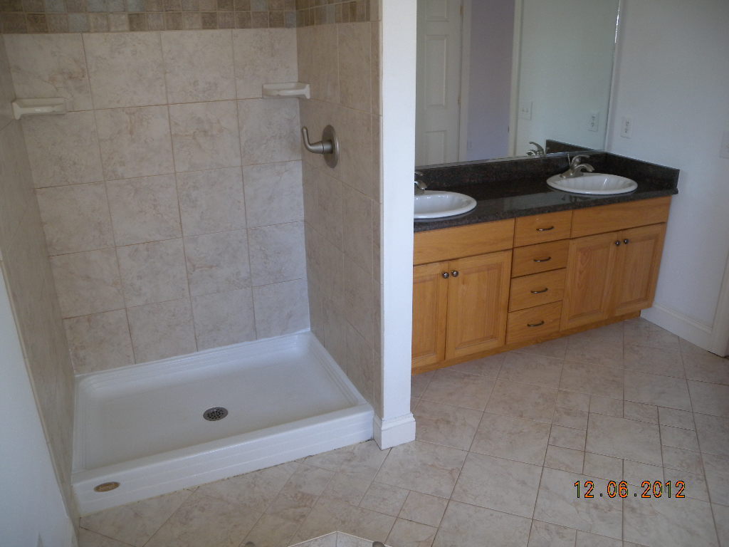 203 Mallard Point Road Wirtz, VA 24184 - Photo 11 of 24 a bathroom with a granite countertop sink a mirror and a bathtub