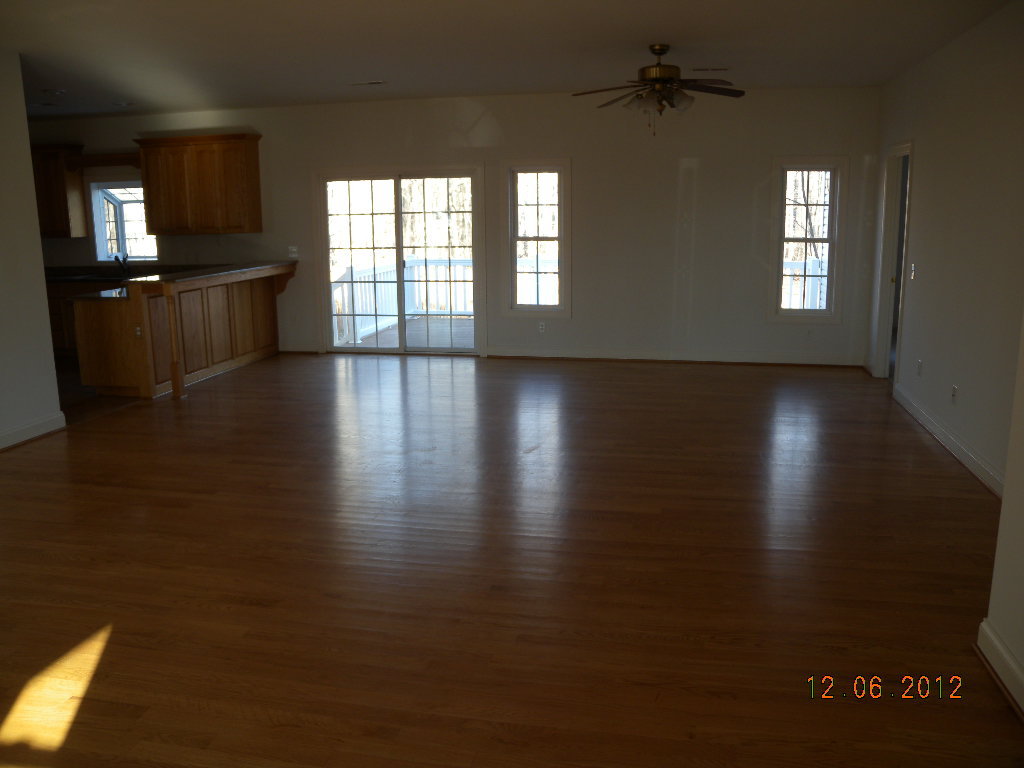 203 Mallard Point Road Wirtz, VA 24184 - Photo 3 of 24 an empty room with wooden floor and windows