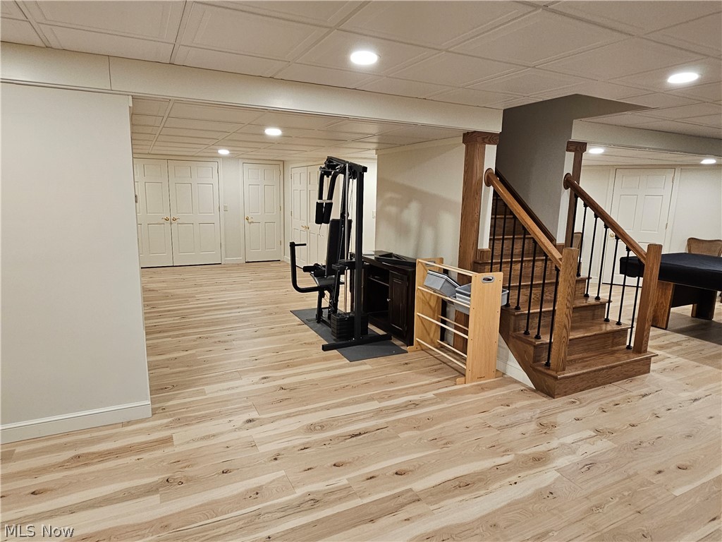 2363 Tabor Ridge Road Northeast New Philadelphia, OH 44663 - Photo 36 of 42 Lower level offering wood-finish flooring, recessed lighting, white paneled doors, and a wood staircase with iron balusters