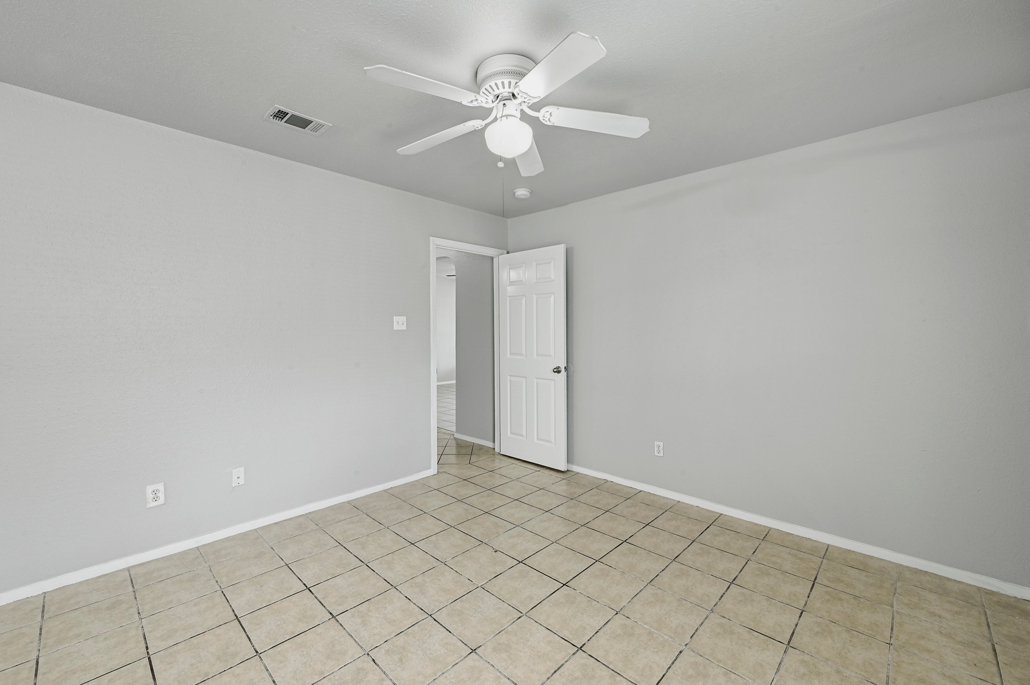 2212 Katy Lane Georgetown, TX 78626 - Photo 18 of 27 This room features neutral-toned walls, tile flooring, and a ceiling fan with an integrated light fixture