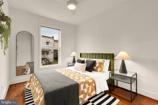 a bedroom with a bed and a lamp