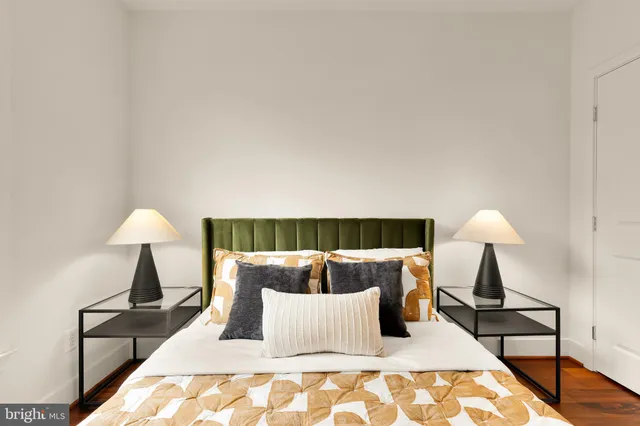 a bedroom with a bed and a painting on the wall