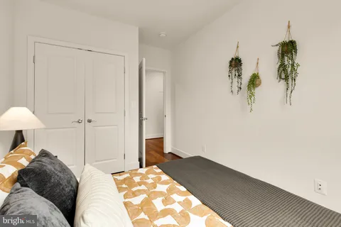 an empty room with a window and a ceiling fan