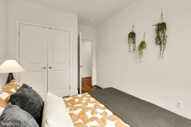 an empty room with a window and a ceiling fan