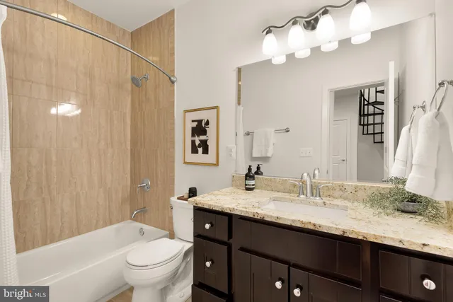 a view of a hallway with wooden floor and stairs