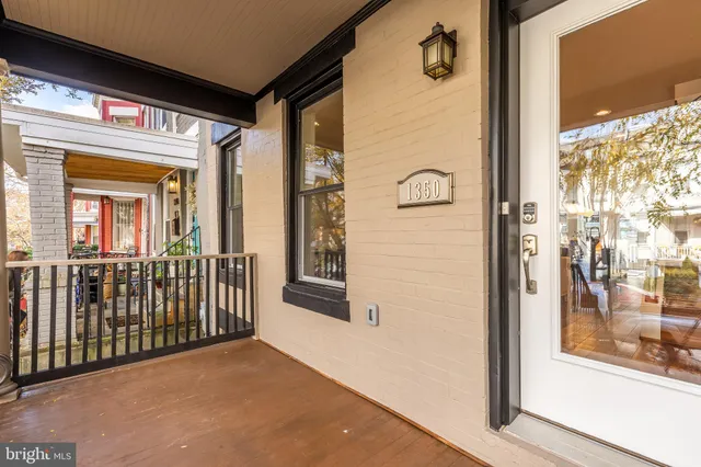 a view of a porch with a table and chairs