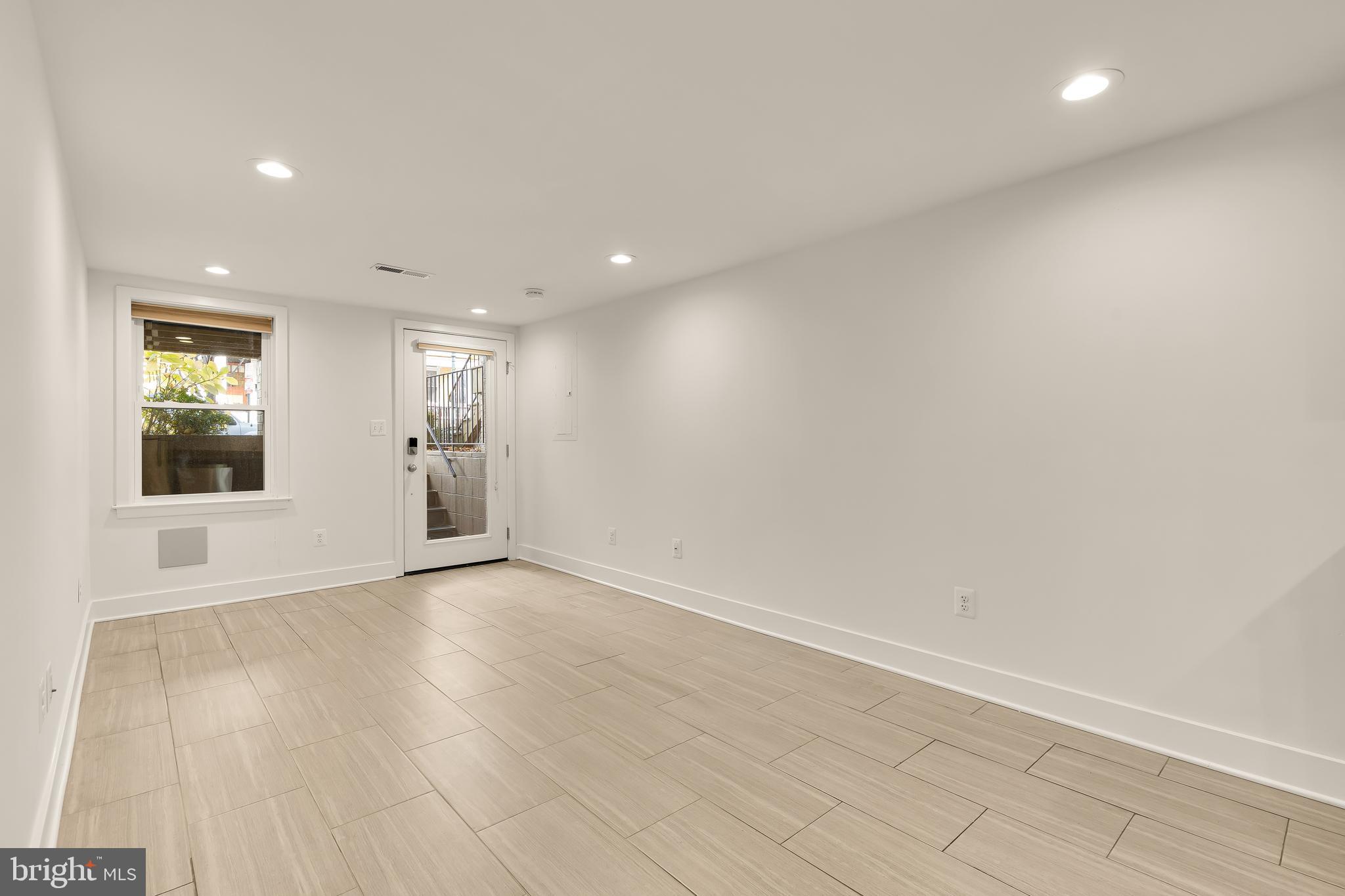 1350 Perry Place Northwest Washington, DC 20010 - Photo 38 of 53 an empty room with wooden floor and windows