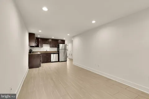 a kitchen with stainless steel appliances a stove microwave and sink