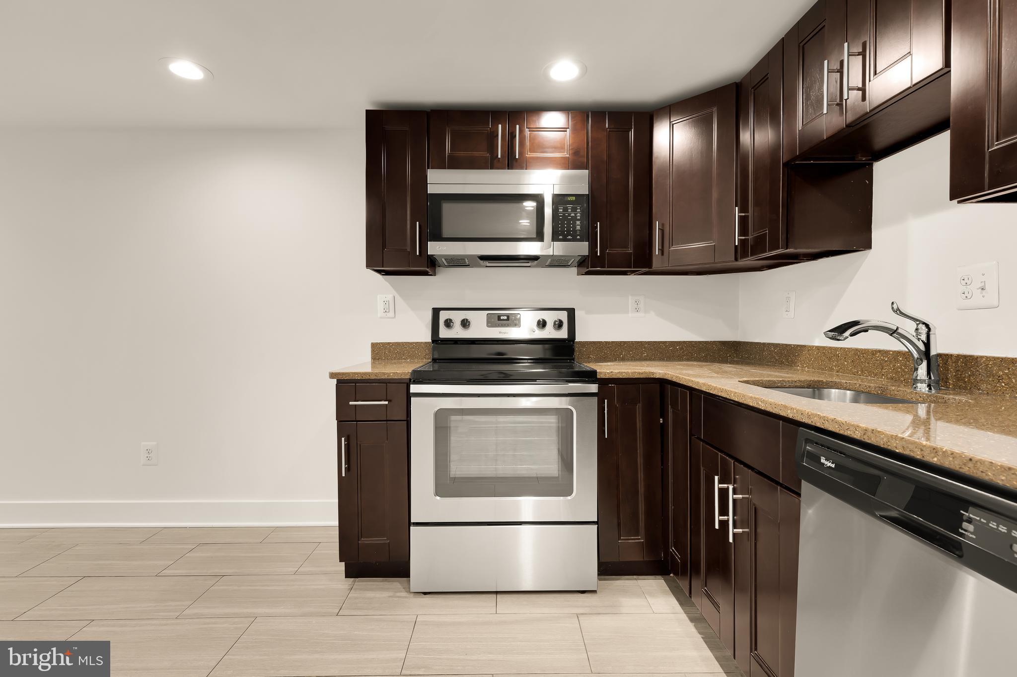 1350 Perry Place Northwest Washington, DC 20010 - Photo 40 of 53 a kitchen with stainless steel appliances a stove microwave and sink
