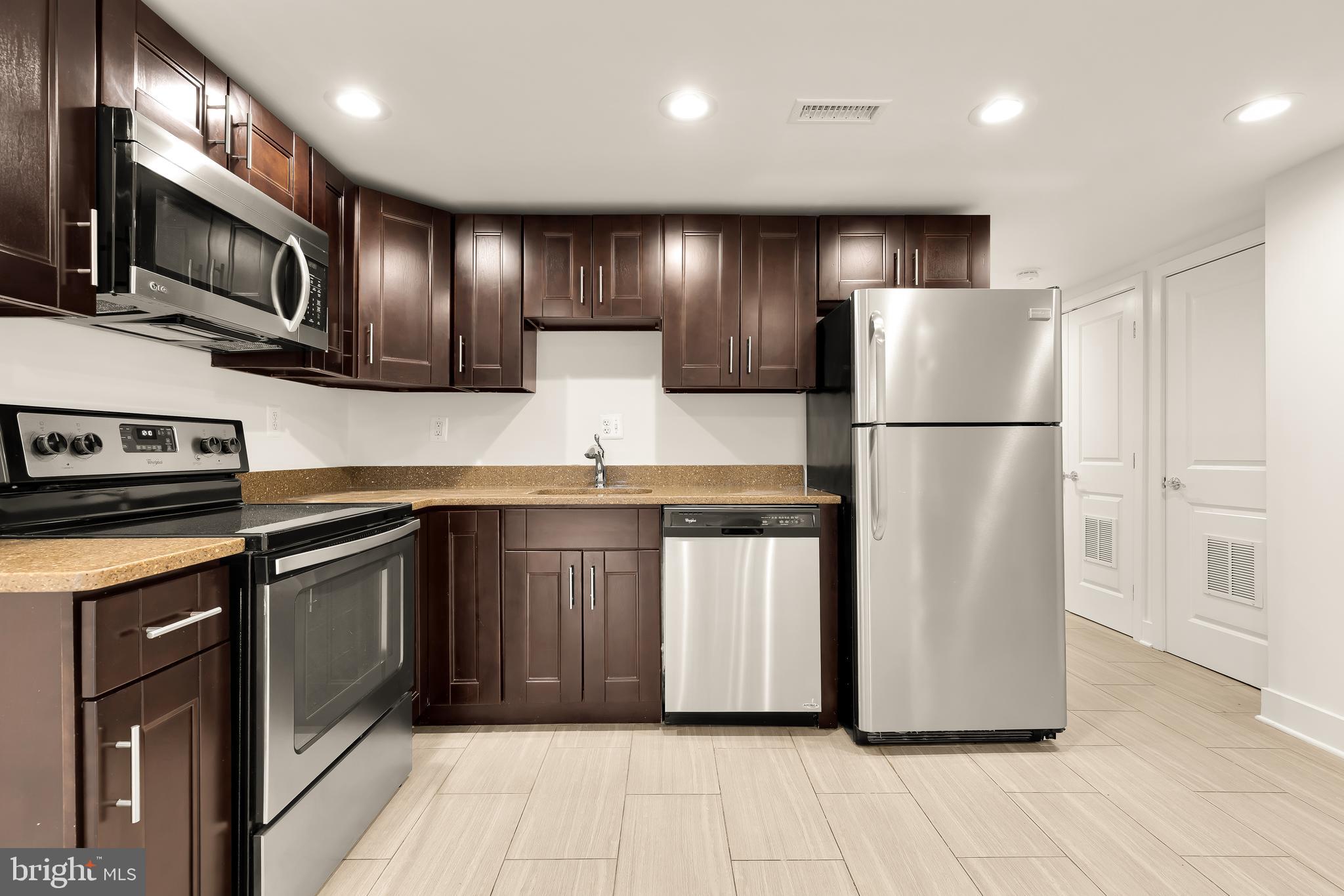 1350 Perry Place Northwest Washington, DC 20010 - Photo 42 of 53 a kitchen with stainless steel appliances granite countertop a refrigerator a stove a sink and a microwave