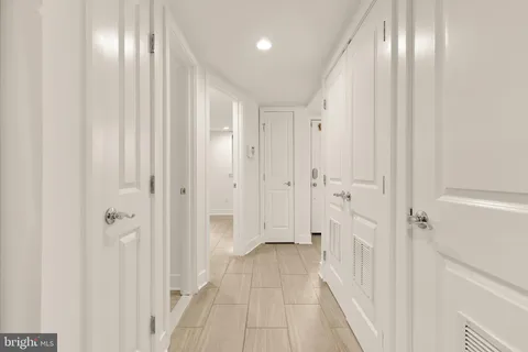 an empty room with windows and closet