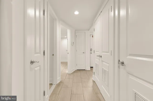 an empty room with windows and closet