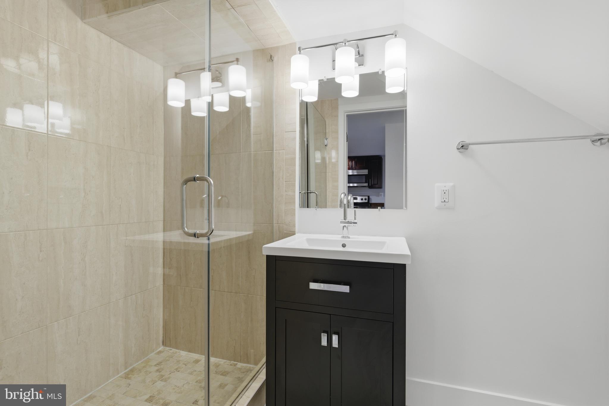 1350 Perry Place Northwest Washington, DC 20010 - Photo 44 of 53 a bathroom with a double vanity sink mirror and shower
