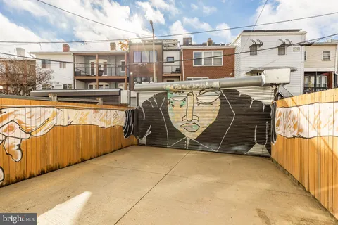 a view of a house with wooden fence