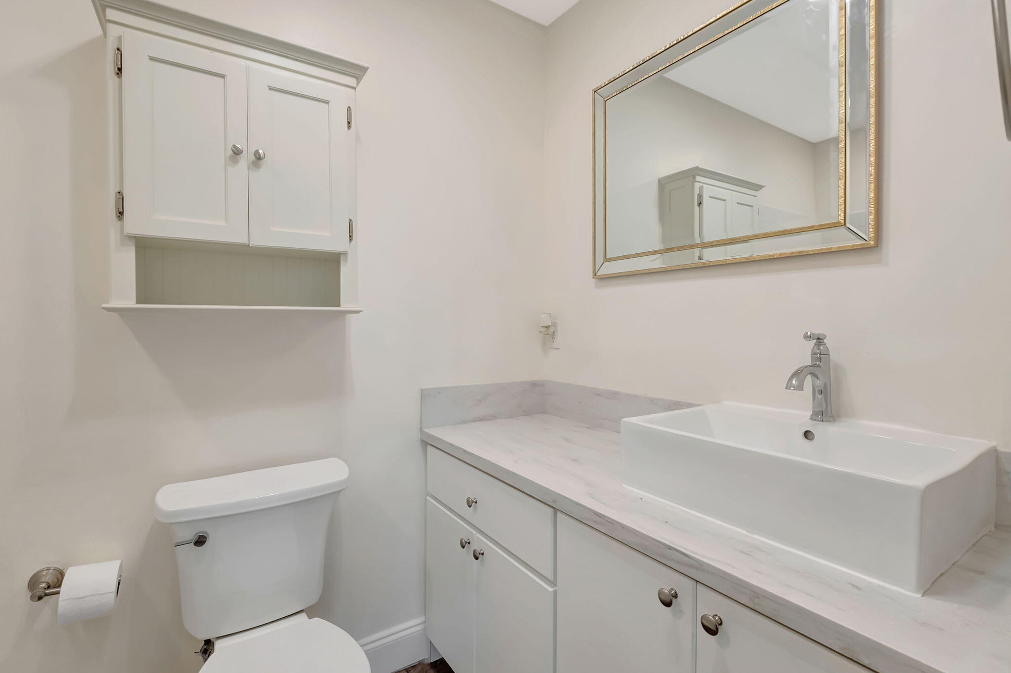 1217 South Drive Way, Unit A Delray Beach, FL 33445 - Photo 18 of 27 a bathroom with a toilet sink and mirror