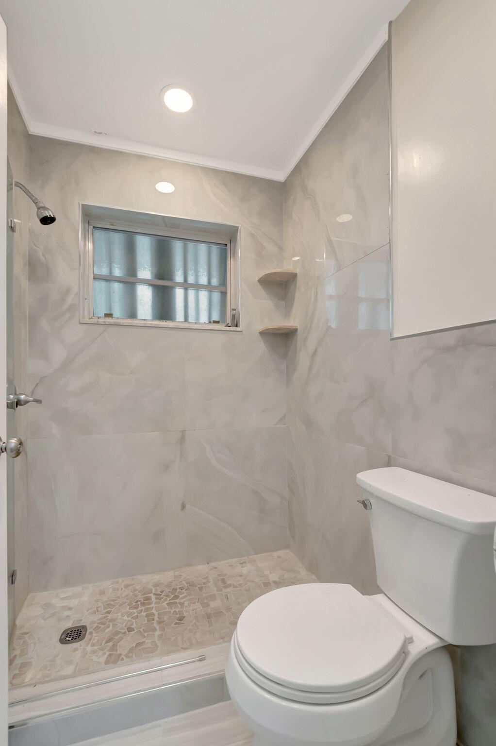 1217 South Drive Way, Unit A Delray Beach, FL 33445 - Photo 25 of 27 a white toilet sitting next to a bathroom