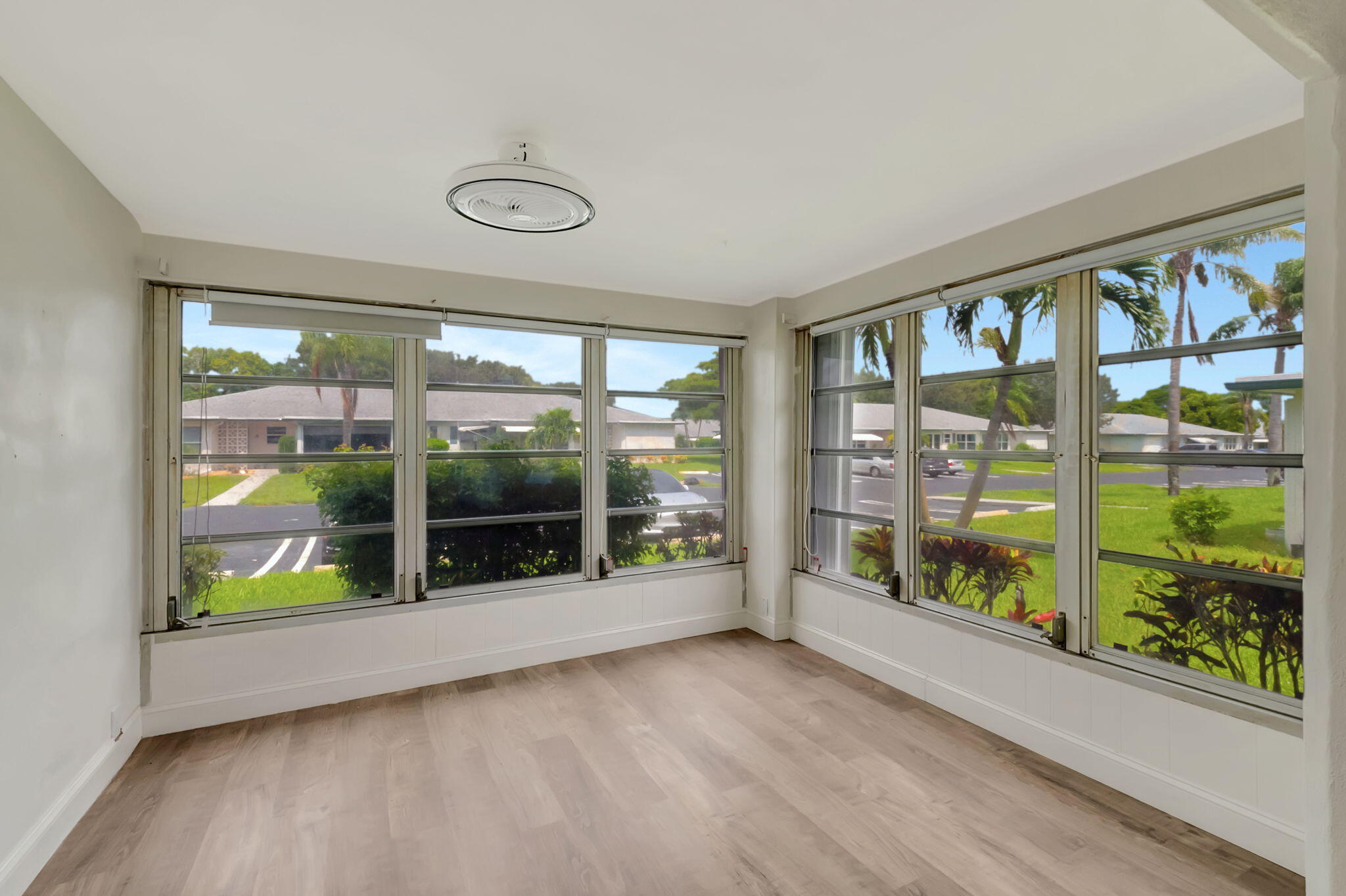 1217 South Drive Way, Unit A Delray Beach, FL 33445 - Photo 9 of 27 a view of an empty room with wooden floor and a window