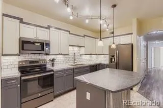 a kitchen with appliances a sink and cabinets