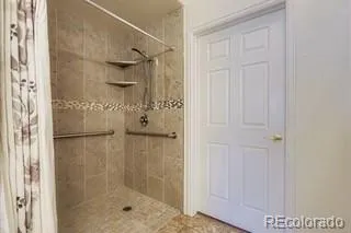a bathroom with a glass shower door