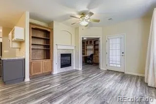 a view of an empty room with a fireplace and a window