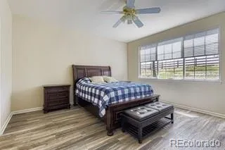 a bedroom with a bed a dresser and a window