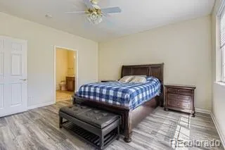 a bedroom with a bed rug and wooden floor