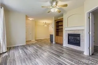 wooden floor fireplace and natural light in empty room