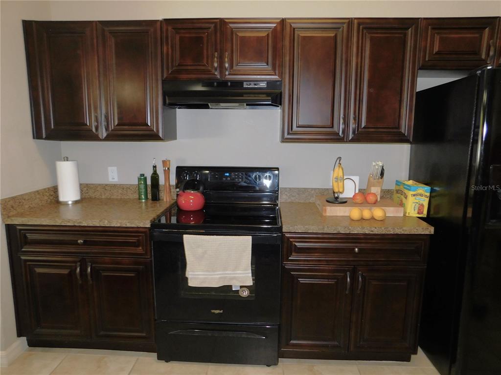 17477 Southwest 36th Terrace Ocala, FL 34473 - Photo 17 of 47 a kitchen with stainless steel appliances granite countertop a stove and a microwave