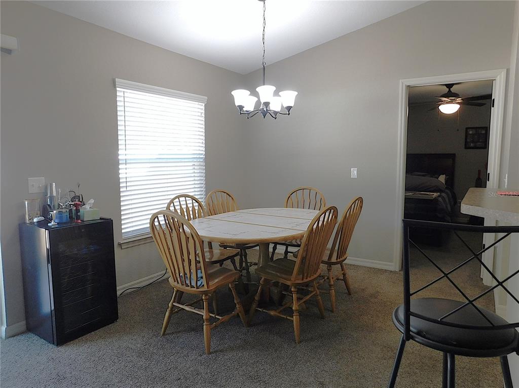 17477 Southwest 36th Terrace Ocala, FL 34473 - Photo 19 of 47 a view of a dining room with furniture window and wooden floor