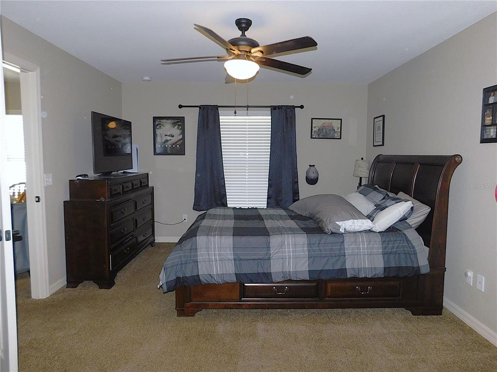 17477 Southwest 36th Terrace Ocala, FL 34473 - Photo 21 of 47 a bedroom with a bed and dresser