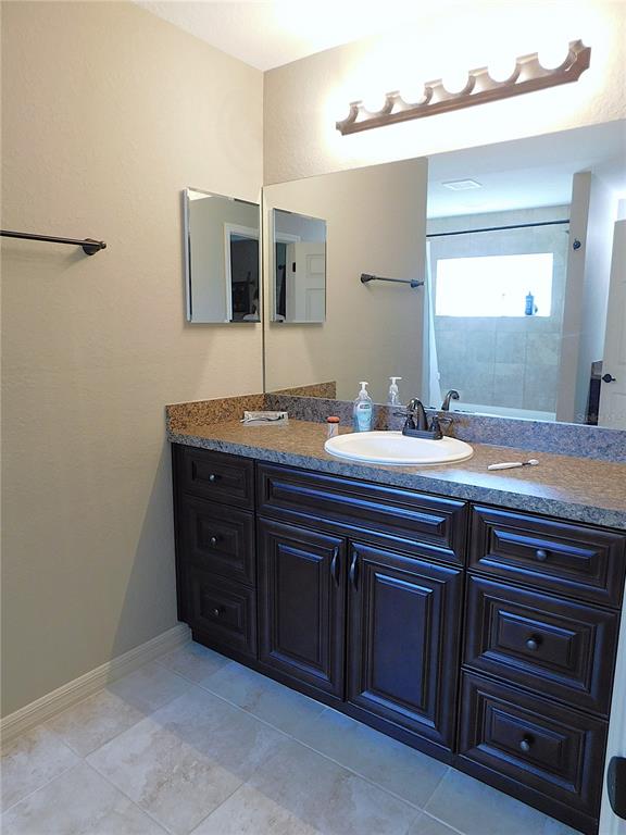 17477 Southwest 36th Terrace Ocala, FL 34473 - Photo 24 of 47 a bathroom with a granite countertop sink and a mirror