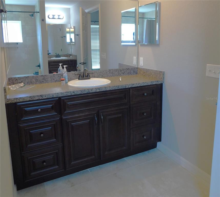 17477 Southwest 36th Terrace Ocala, FL 34473 - Photo 25 of 47 a bathroom with a granite countertop sink and a mirror
