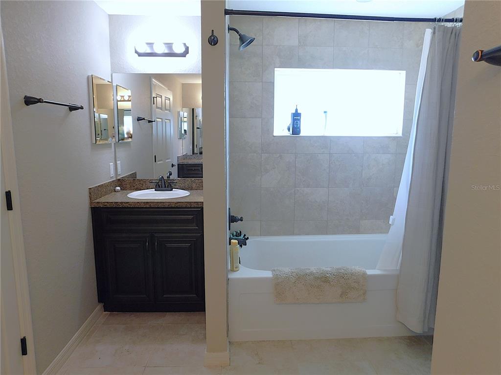 17477 Southwest 36th Terrace Ocala, FL 34473 - Photo 26 of 47 a bathroom with a tub sink and mirror