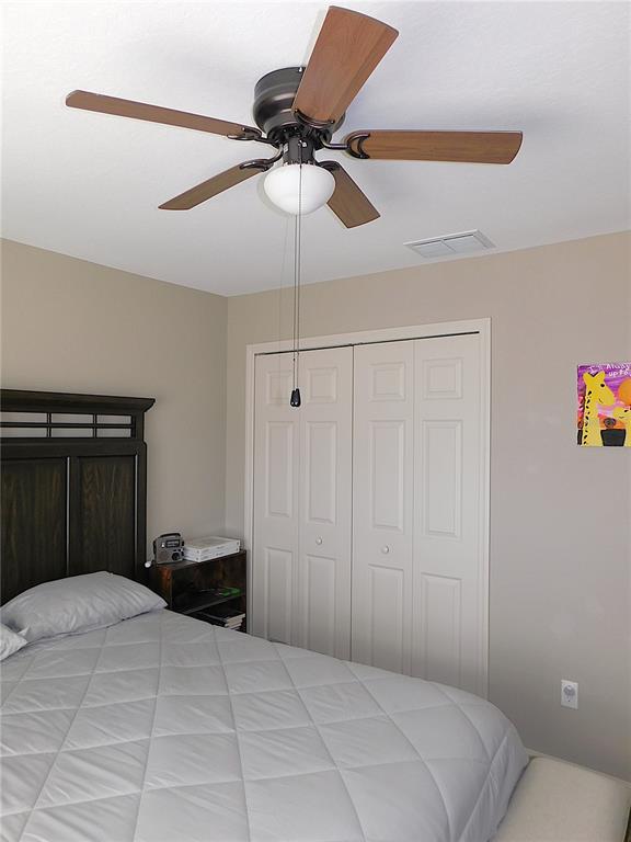 17477 Southwest 36th Terrace Ocala, FL 34473 - Photo 32 of 47 a bedroom with a bed and a chandelier