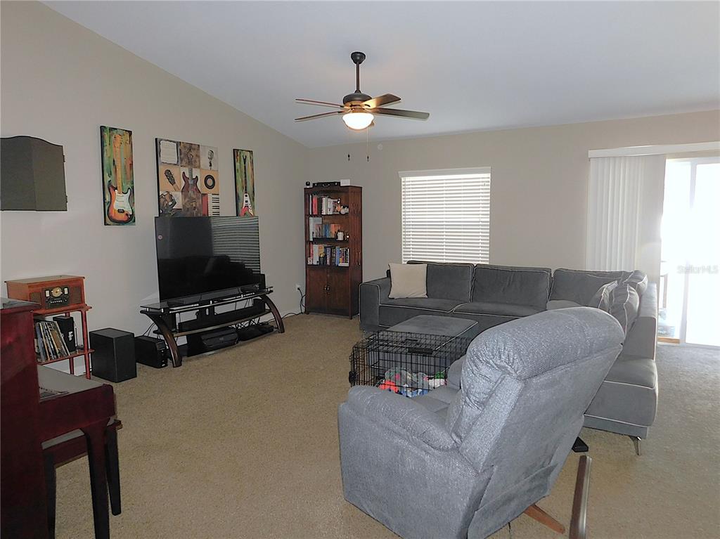 17477 Southwest 36th Terrace Ocala, FL 34473 - Photo 9 of 47 a living room with furniture and a air conditioner vent