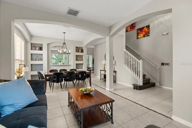 a living room with furniture and a dining table