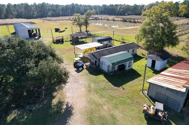 a aerial view of a house with outdoor space and lake view