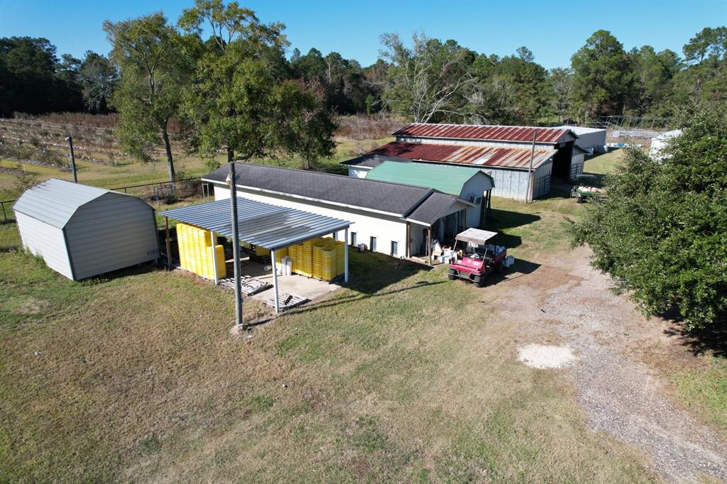 6934 Biscamp Road Silsbee, TX 77656 - Photo 19 of 38 a roof deck with table and chairs under an umbrella