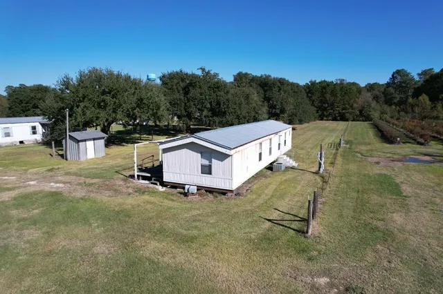a aerial view of a house with table and chairs