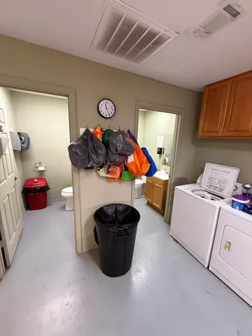 a bedroom with furniture and a lamp