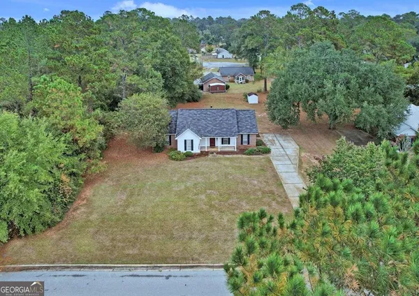 an aerial view of a house with a yard
