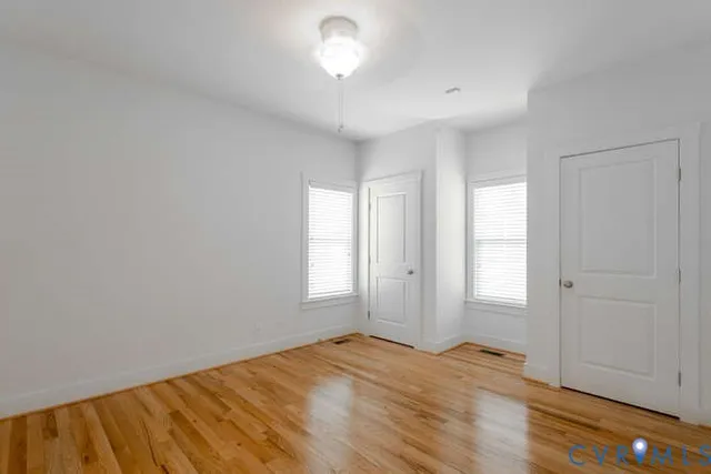 wooden floor in an empty room with a window