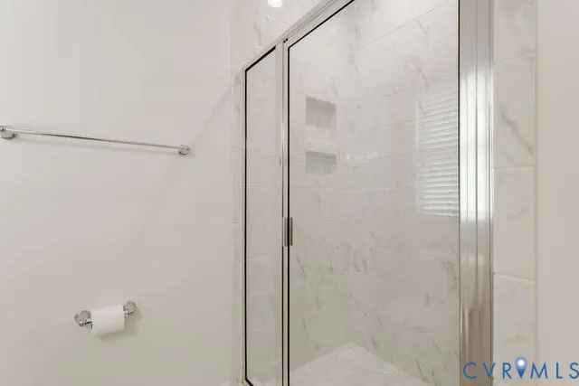 a bathroom with a glass shower door